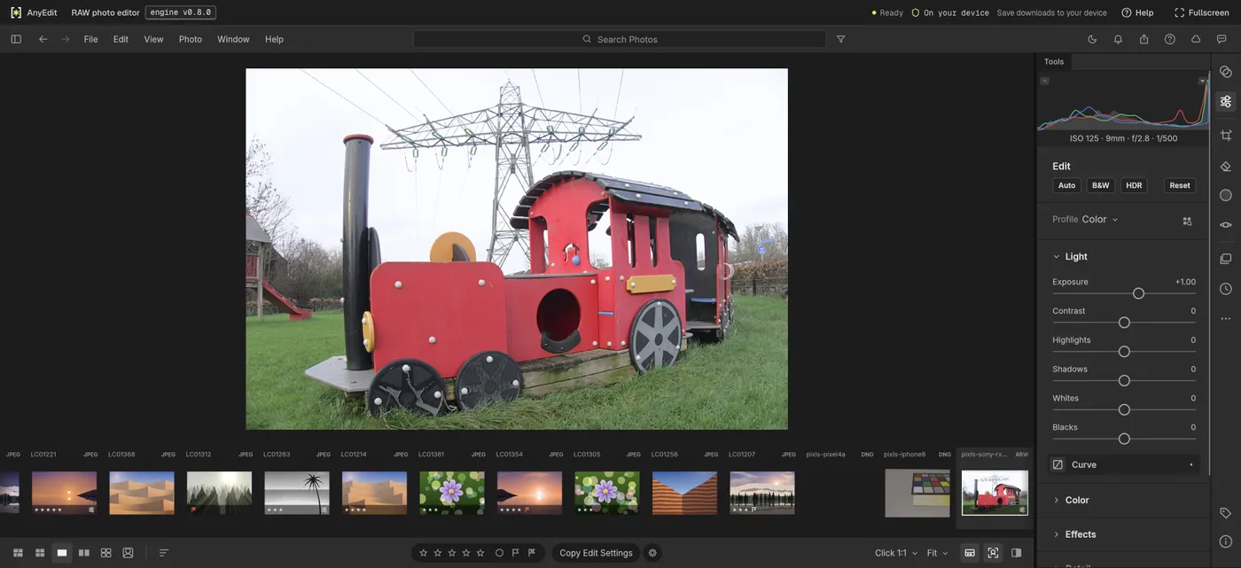 The RAW photo editor with a Sony RX100 III .arw photo of a red toy train open, exposure set to +1.00, the histogram above it and the imported ARW in the filmstrip